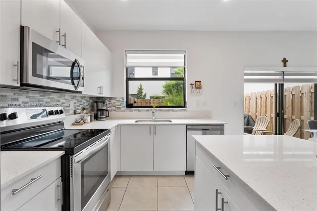 a kitchen with a sink stove and cabinets