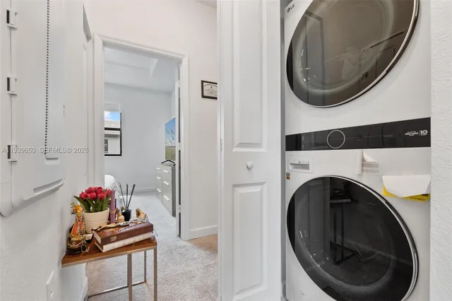 a view of a hallway with washer and dryer