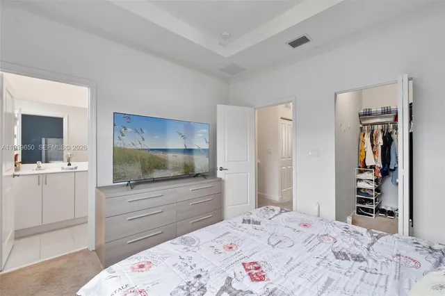 a bedroom with a bed and a television