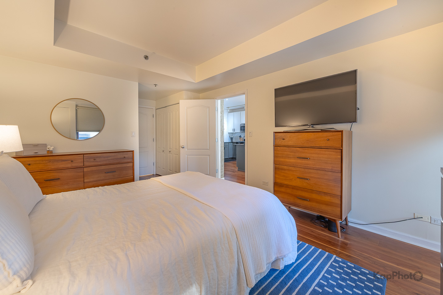 1212 North Wells Street, Unit 303 Chicago, IL 60610 - Photo 12 of 22 a bedroom with a bed and a dresser