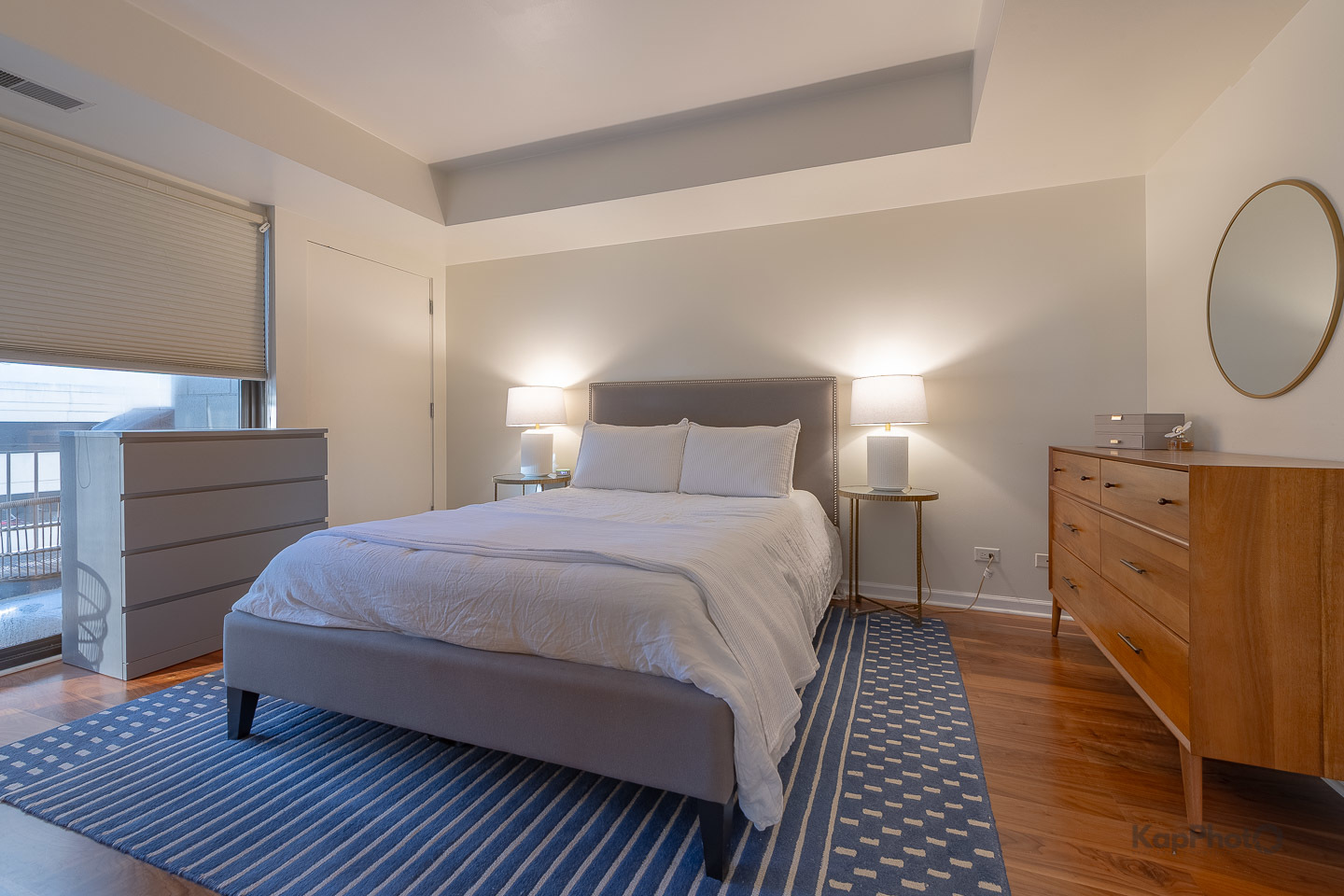 1212 North Wells Street, Unit 303 Chicago, IL 60610 - Photo 13 of 22 a bedroom with a bed and cabinets