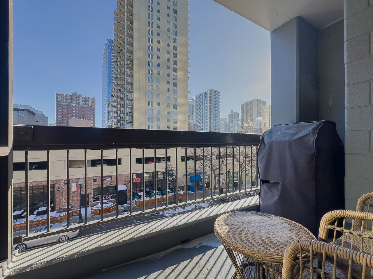 1212 North Wells Street, Unit 303 Chicago, IL 60610 - Photo 19 of 22 a balcony with table and chairs
