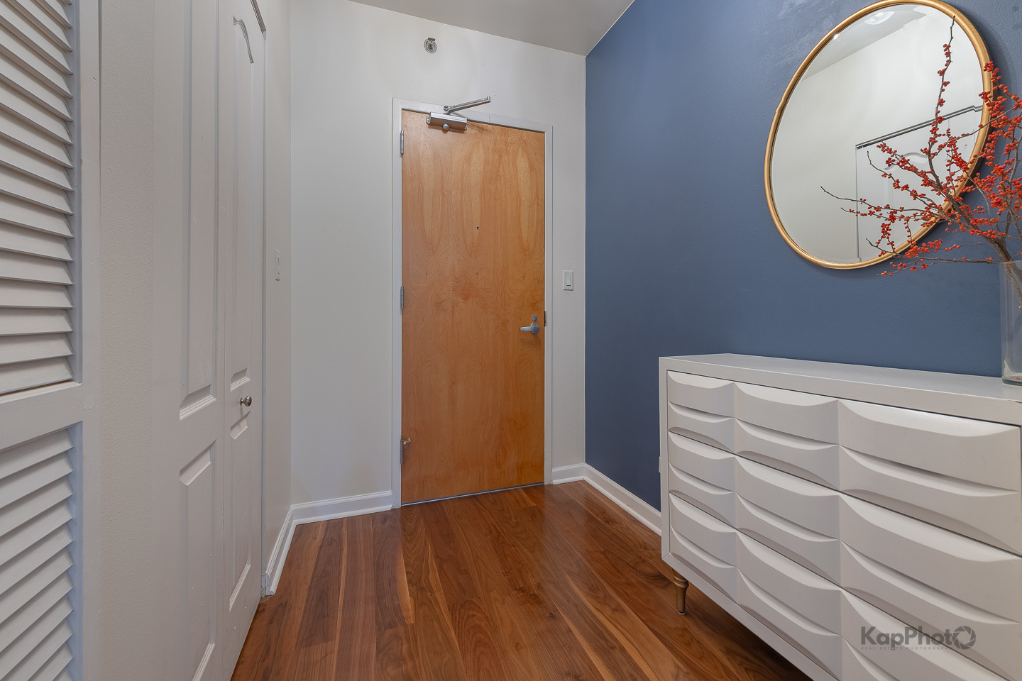 1212 North Wells Street, Unit 303 Chicago, IL 60610 - Photo 3 of 22 a view of a hallway with wooden floor and a chandelier