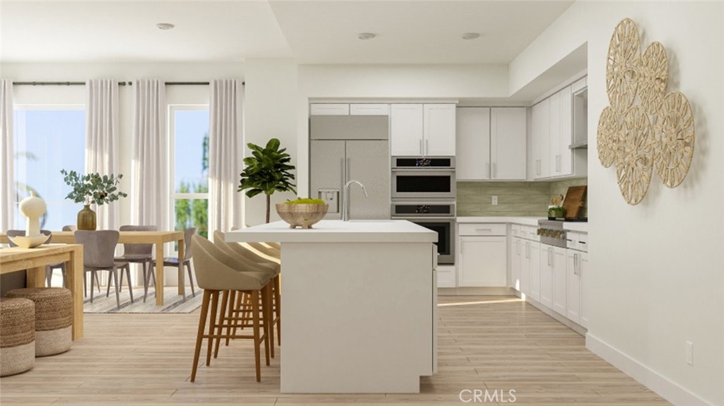 3301 Rivington Irvine, CA 92612 - Photo 1 of 1 a kitchen with a table chairs refrigerator and cabinets