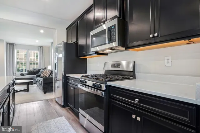 a kitchen with stainless steel appliances granite countertop a stove and a refrigerator