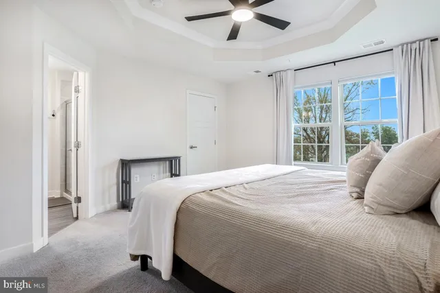 a bedroom with a large bed and a chandelier