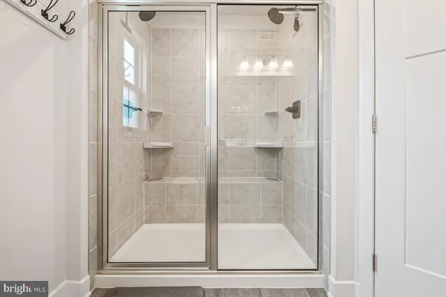 a bathroom with a glass shower door