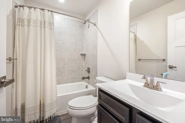 a bathroom with a sink a toilet and a bathtub