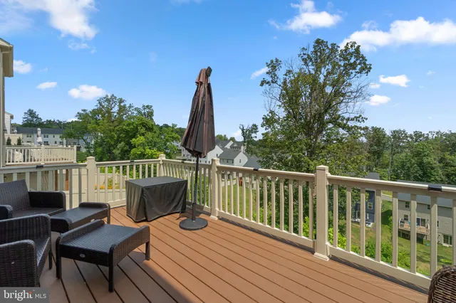 a view of a balcony with wooden floor and outdoor seating