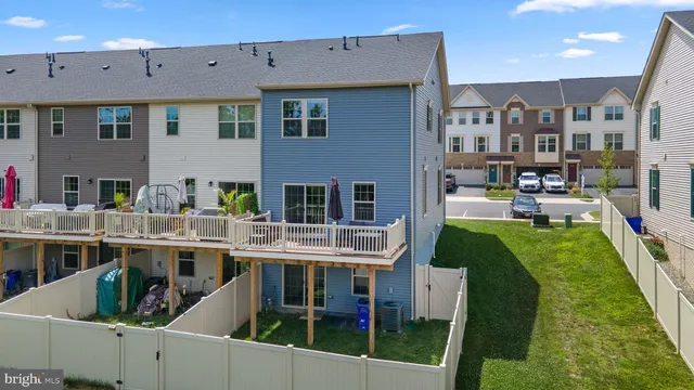 a view of multiple houses with a swimming pool