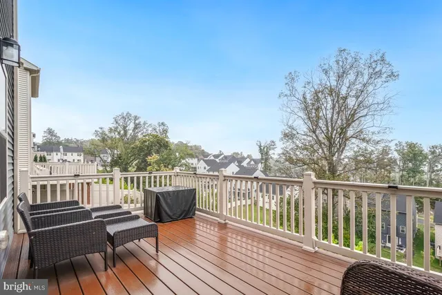 a view of a balcony with wooden floor and fence