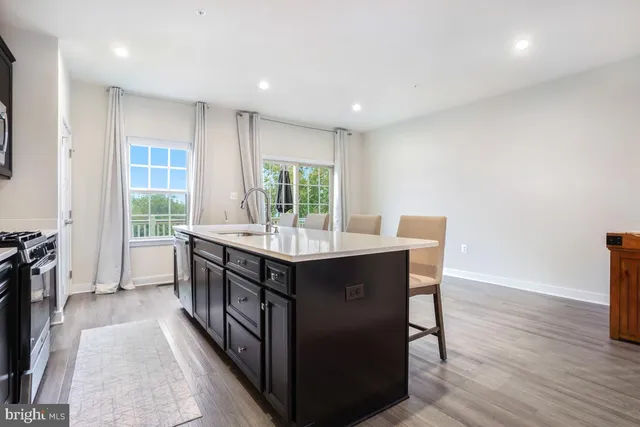a kitchen with counter top space and wooden floor