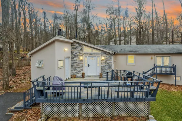 a view of a chairs and table in the back yard of the house