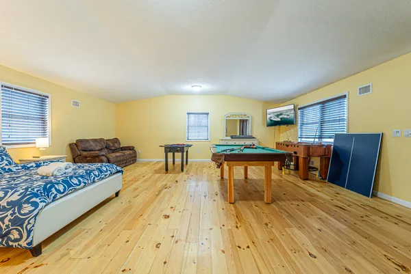a living room with furniture and a wooden floor