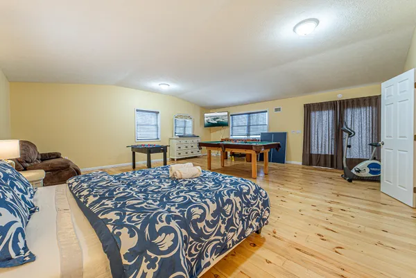 a bed room with a bed and a chair