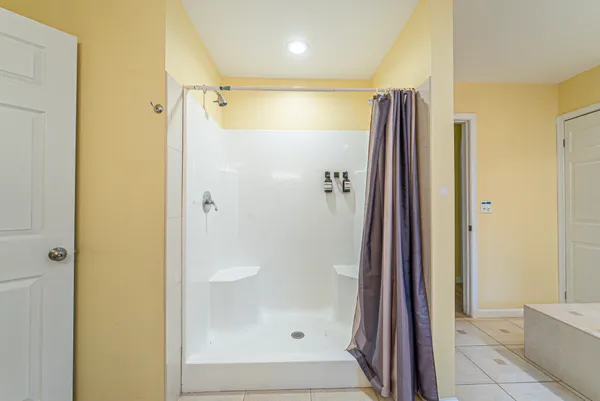 a bathroom with a shower and a glass door