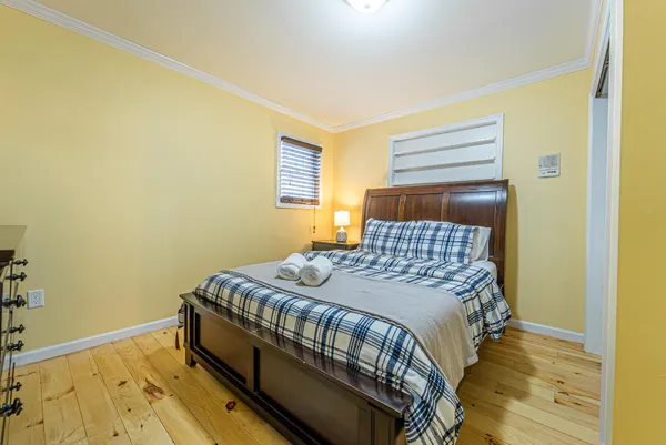 a bed sitting in a bedroom next to a window