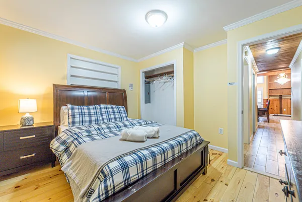 a bedroom with a bed and wooden floor