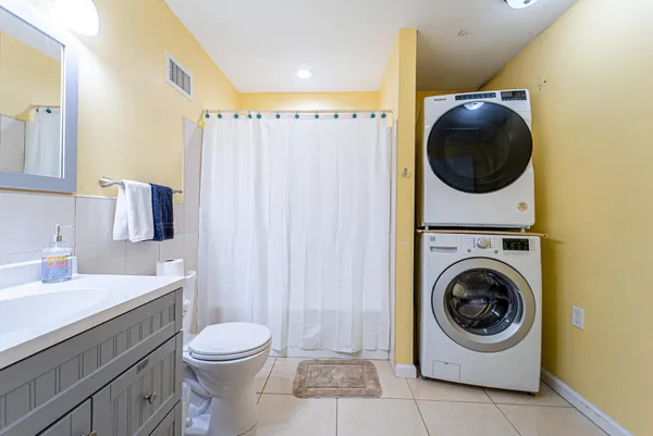 a bathroom with a sink a washer and dryer