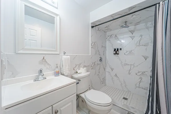 a bathroom with a sink toilet and shower