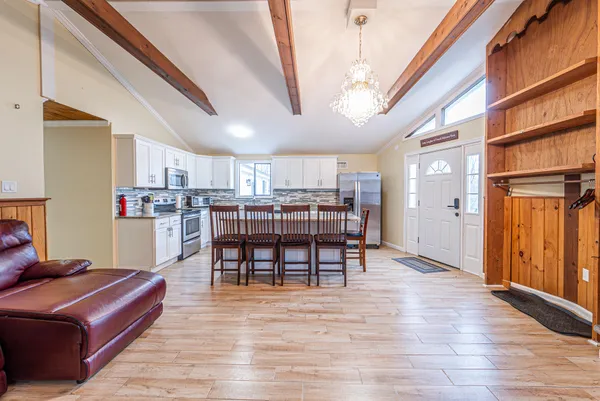 a living room with stainless steel appliances kitchen island granite countertop furniture and a kitchen view