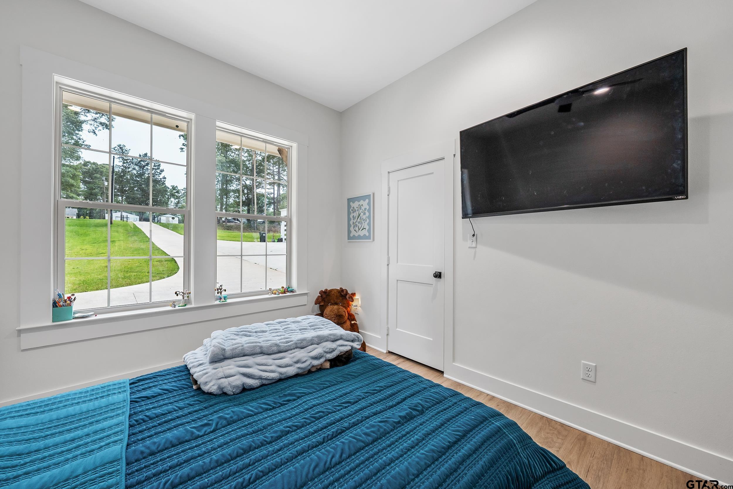 16837 Wilson Road Tyler, TX 75707 - Photo 30 of 44 a bedroom with a bed and a flat screen tv