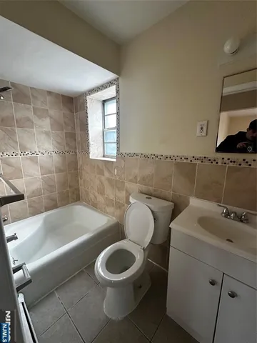 a bathroom with a toilet a sink and bathtub