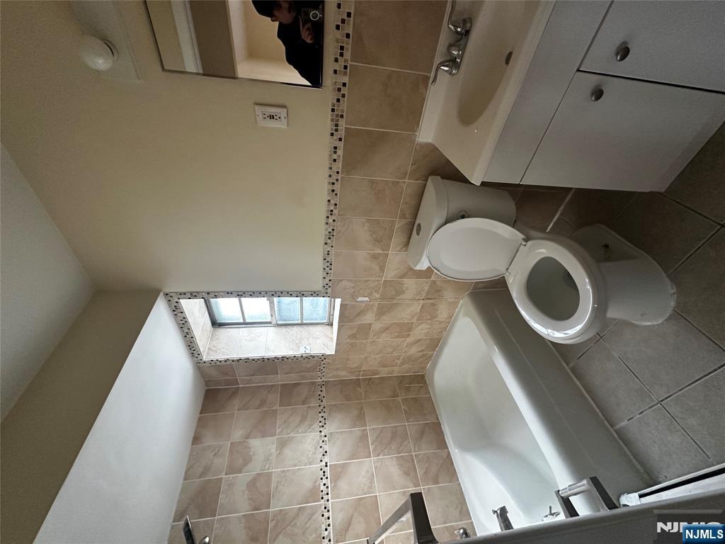 a bathroom with a toilet a sink and bathtub