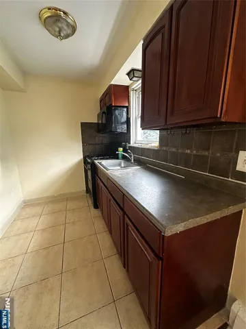 a kitchen with stainless steel appliances a sink dishwasher stove and cabinets