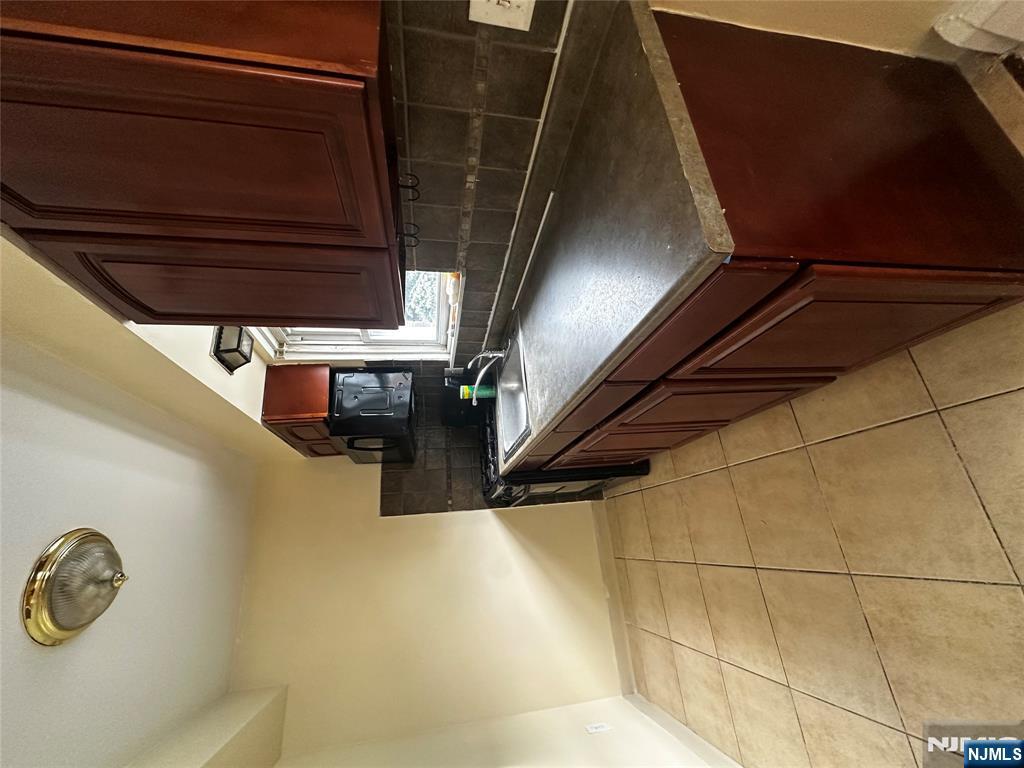 218 Cliff Street, Unit 1 Cliffside Park, NJ 07010 - Photo 4 of 7 a kitchen with stainless steel appliances a sink dishwasher stove and cabinets
