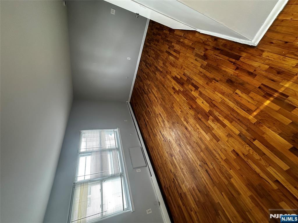 218 Cliff Street, Unit 1 Cliffside Park, NJ 07010 - Photo 6 of 7 an empty room with wooden floor and windows