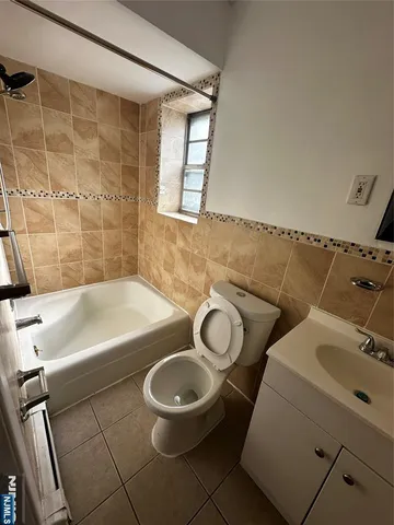 a bathroom with a sink mirror vanity and toilet