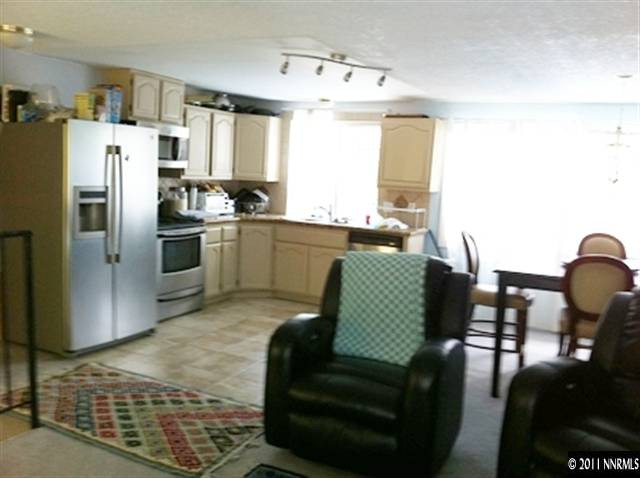 3660 Renee Way Reno, NV 89503 - Photo 2 of 6 a kitchen with stainless steel appliances granite countertop a refrigerator and a stove top oven