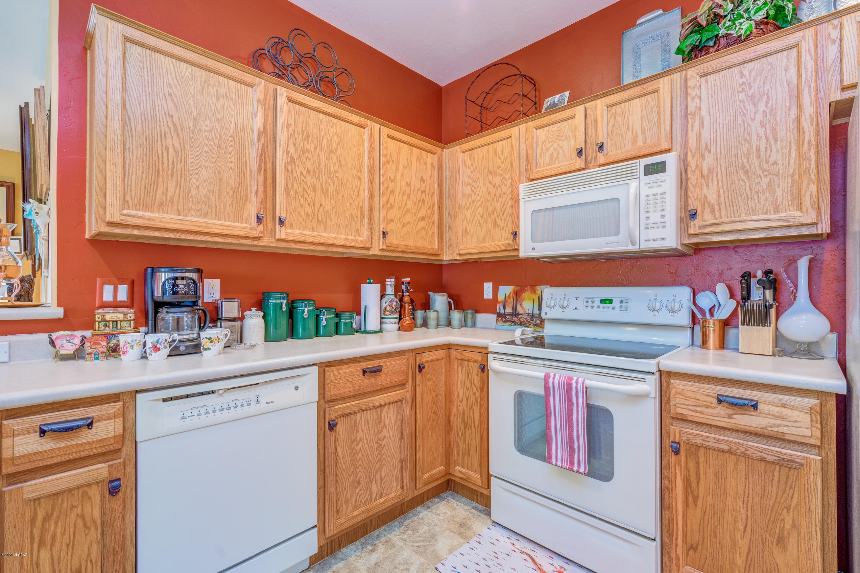 3640 East Northern Dancer Road Tucson, AZ 85739 - Photo 23 of 47 a kitchen with a sink stove and cabinets