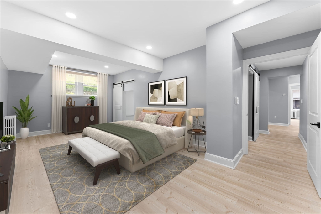 127 Winthrop Road, Unit 12A Brookline, MA 02445 - Photo 20 of 41 a spacious bedroom with a bed and a couch