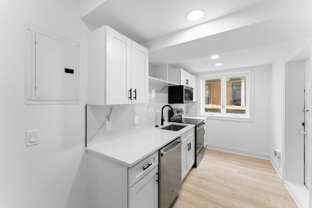 127 Winthrop Road, Unit 12A Brookline, MA 02445 - Photo 6 of 41 a kitchen with a stove a sink and a refrigerator