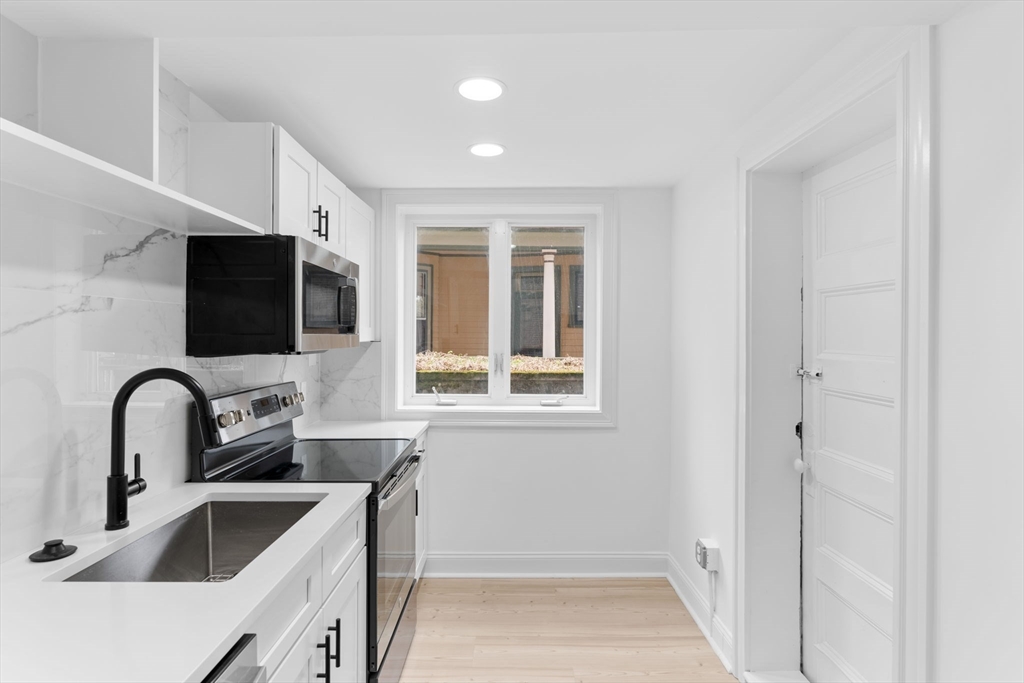 127 Winthrop Road, Unit 12A Brookline, MA 02445 - Photo 8 of 41 a kitchen with a sink and a refrigerator