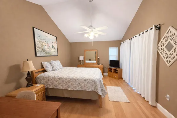 a bedroom with a bed and a dresser