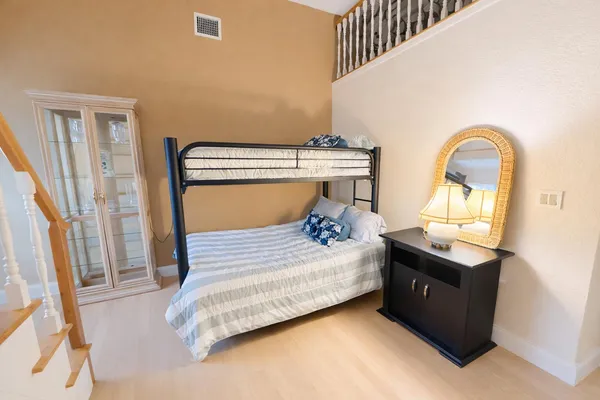 a bedroom with two beds and a flat screen tv