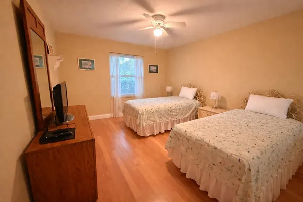 a spacious bathroom with a granite countertop sink a toilet and a mirror