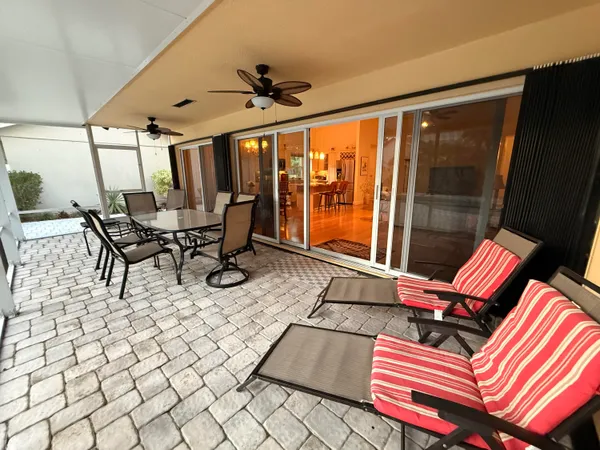 a swimming pool with outdoor seating and yard
