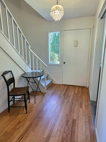 a view of a livingroom with furniture wooden floor and windows