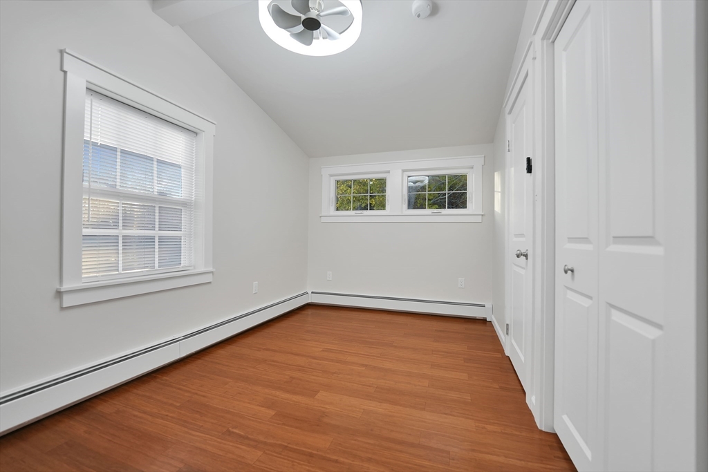 245 Wareham Road Marion, MA 02738 - Photo 20 of 42 a view of an empty room with wooden floor and a window