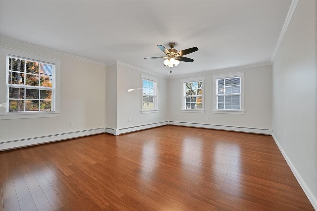 245 Wareham Road Marion, MA 02738 - Photo 30 of 42 a view of an empty room with windows and wooden floor