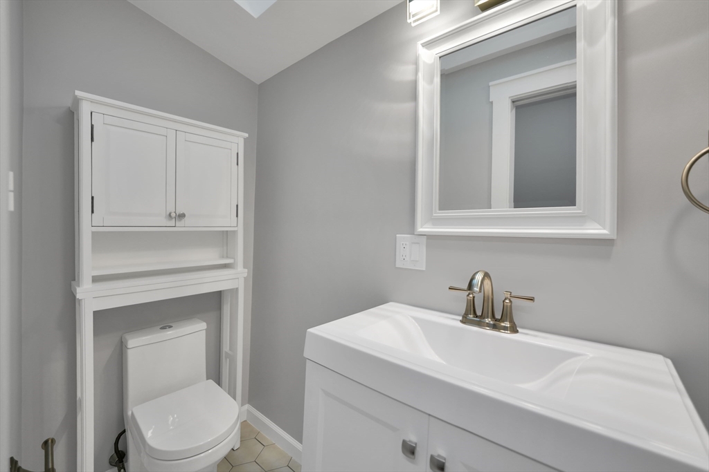 245 Wareham Road Marion, MA 02738 - Photo 34 of 42 a bathroom with a toilet sink vanity and mirror