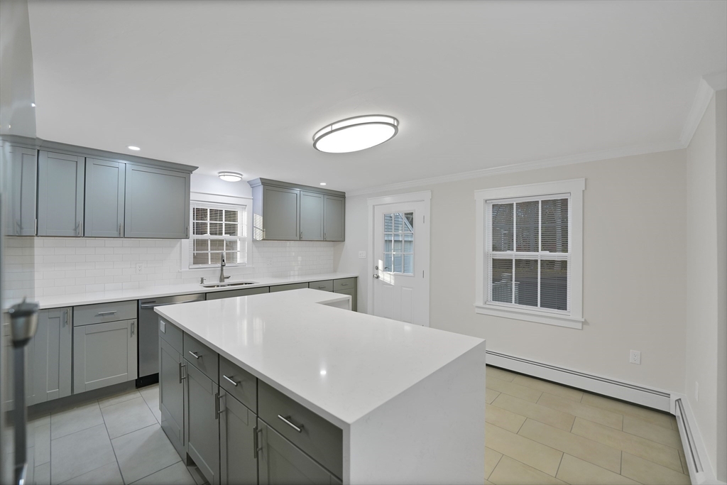 245 Wareham Road Marion, MA 02738 - Photo 10 of 42 a kitchen with a stove a sink a microwave and cabinets