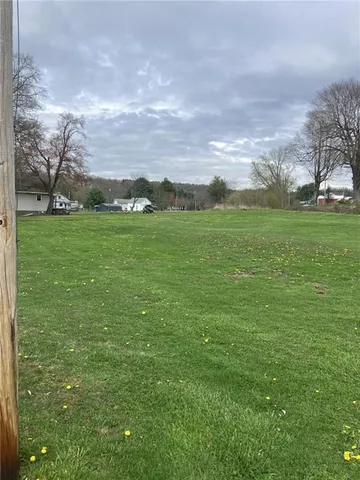 a view of grassy field with mountain