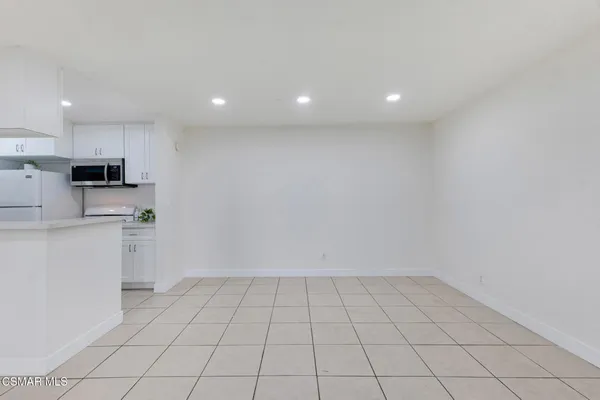 a view of kitchen with white cabinets
