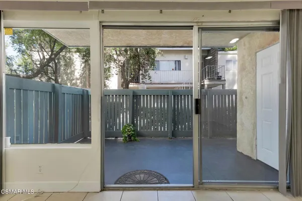 a view of a porch with wooden floor and fence