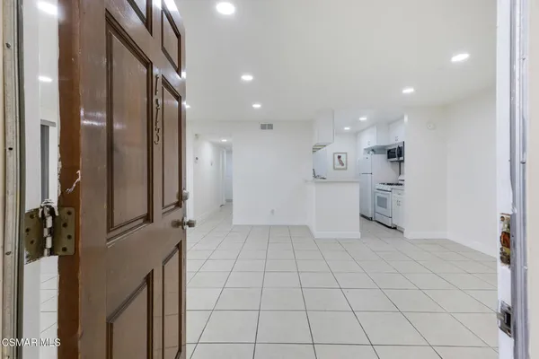a kitchen with stainless steel appliances a refrigerator and a stove top oven